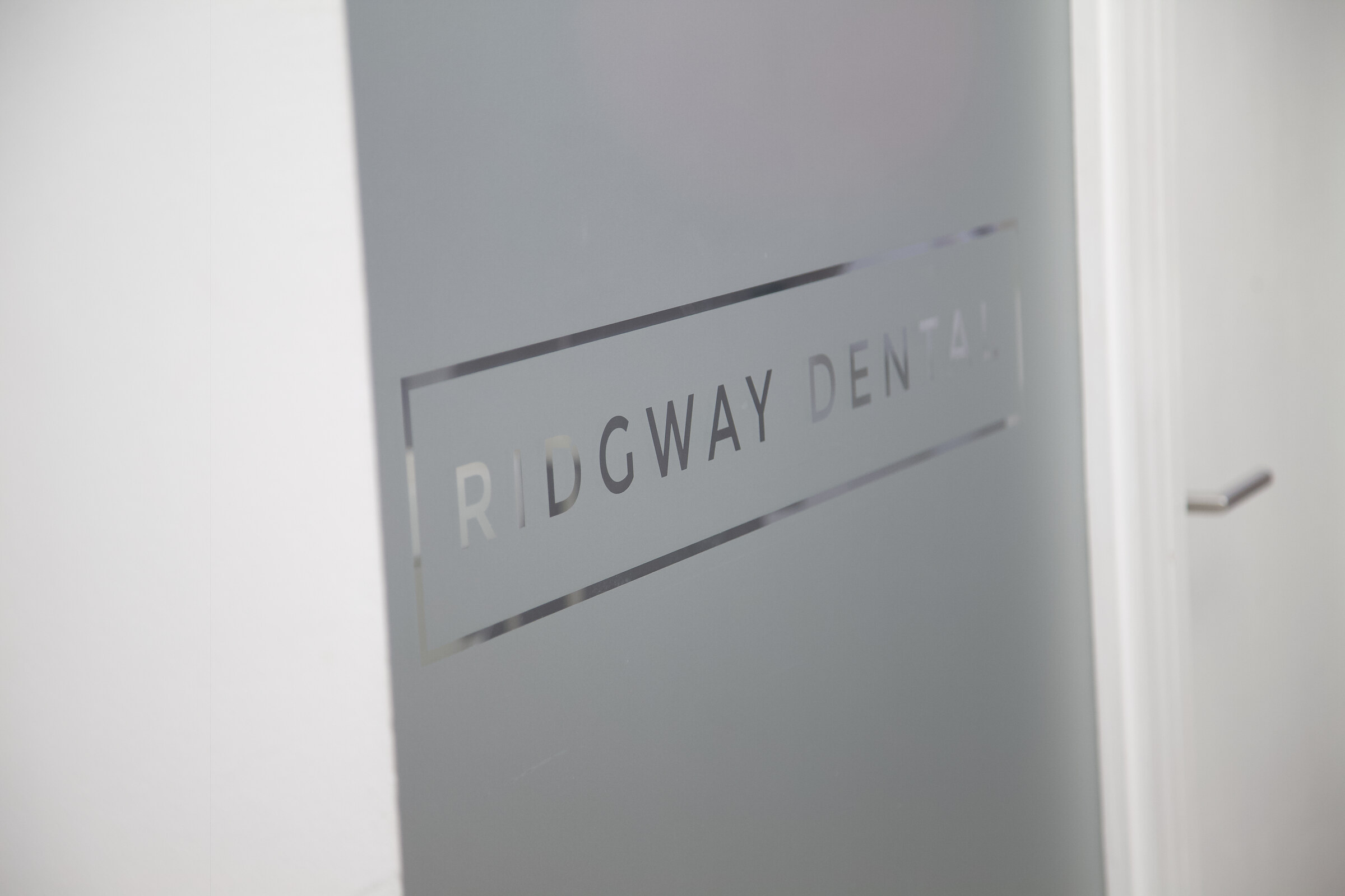 The Ridgway Dental logo etched on the glass door
